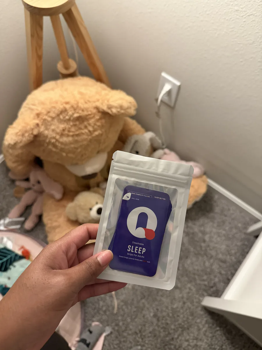 Maya holding a pouch of Sleep Que-Strips packets