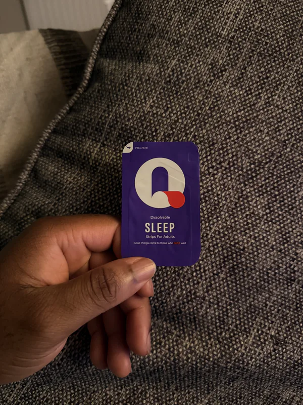 Silas holding a Sleep Que-Strips packet